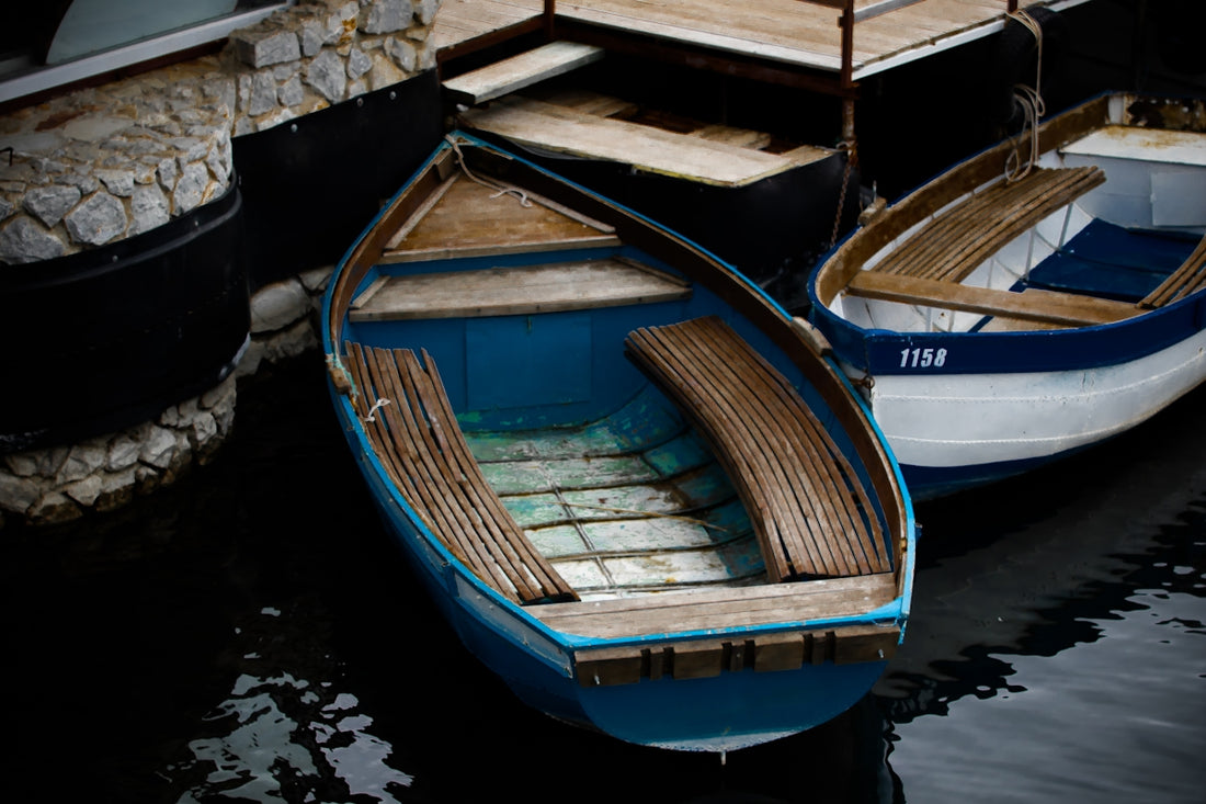 blue and brown wooden boat on water during daytime