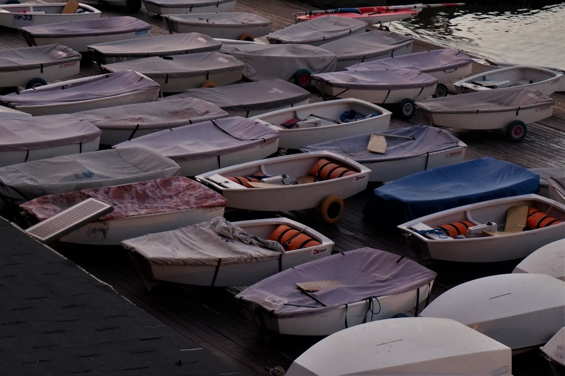 a group of boats parked on the pavement