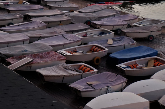 a group of boats parked on the pavement