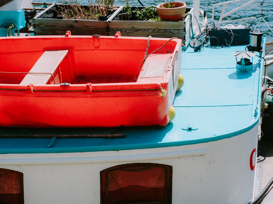 a red and white boat sitting on top of a body of water