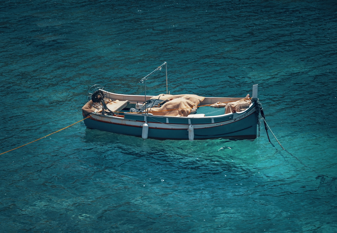a small boat floating on top of a body of water