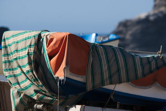 A boat covered in a blanket on a beach