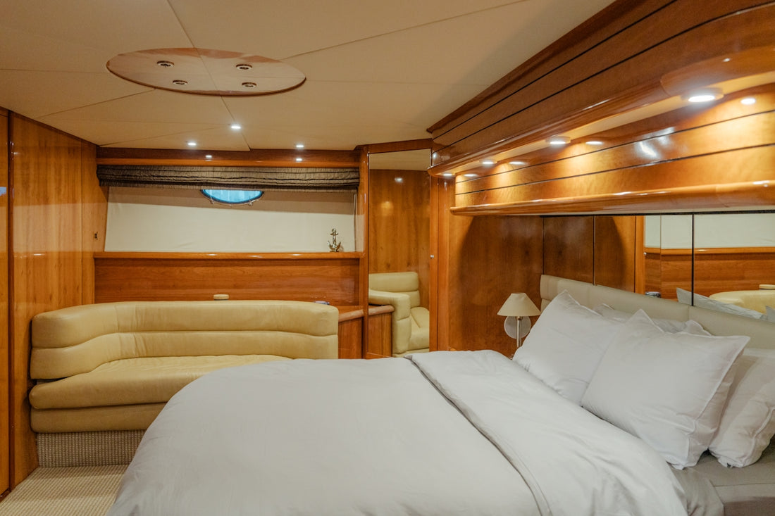 A bed sitting inside of a bedroom on a boat